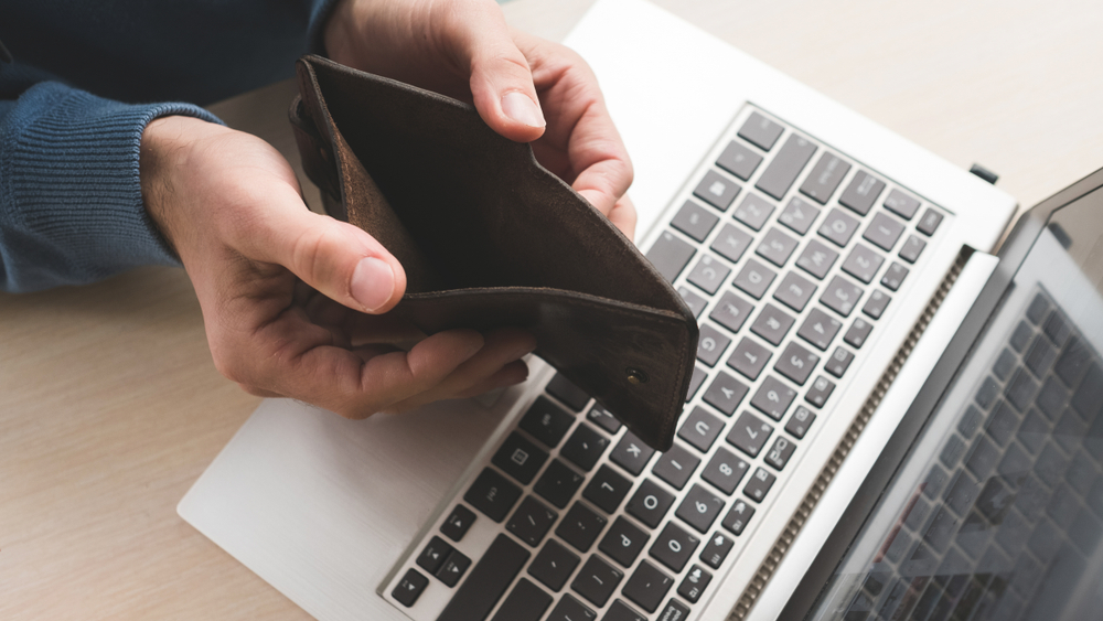 empty wallet and a laptop