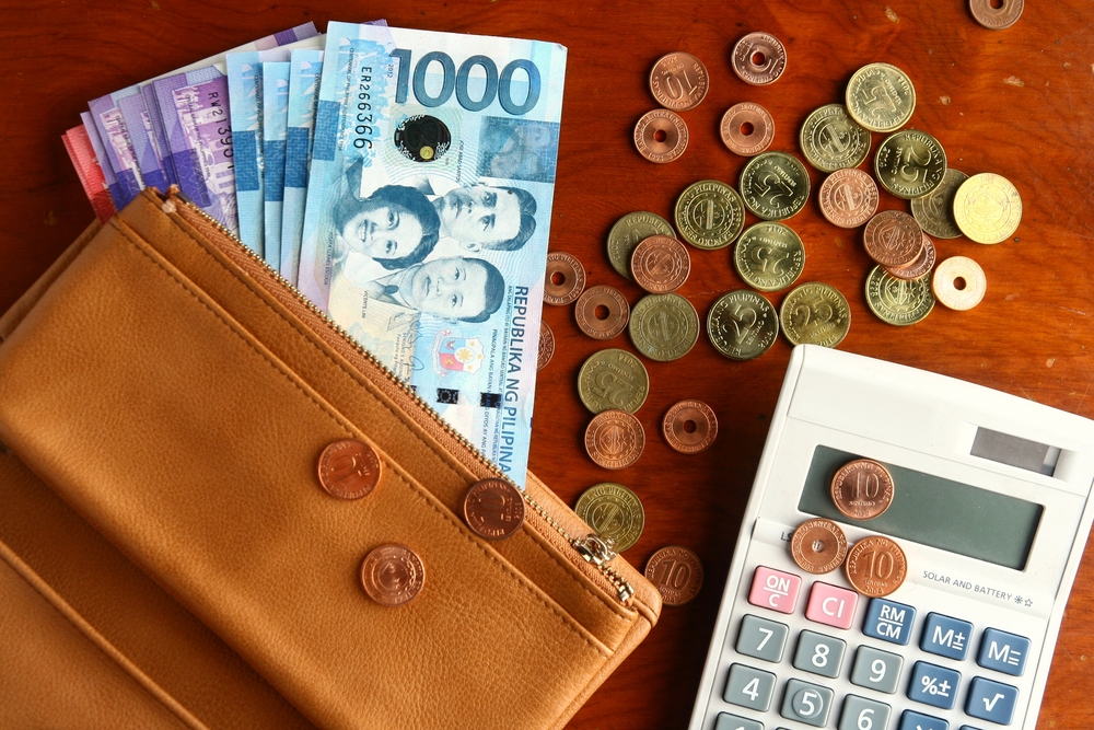 coins and bills with calculator