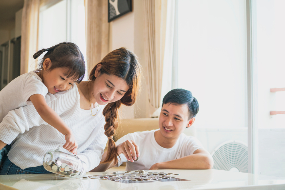 two girls and a boy counting coins